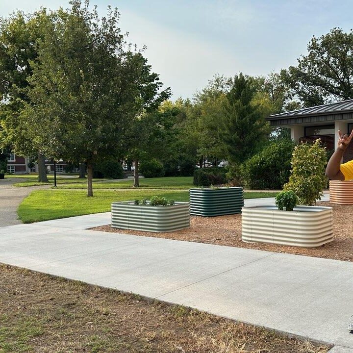 Man standing in front of open space on campus