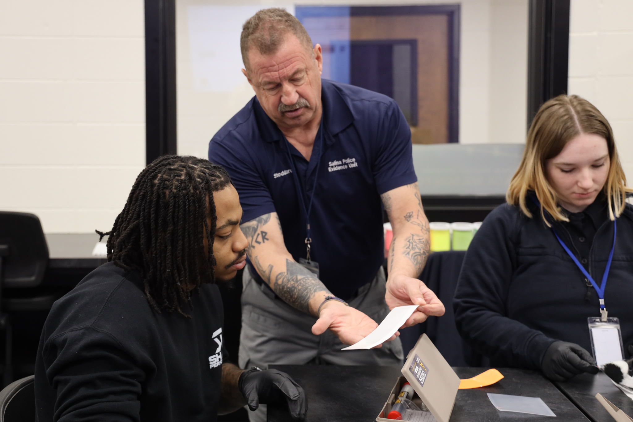 Instructor and students inside crime lab