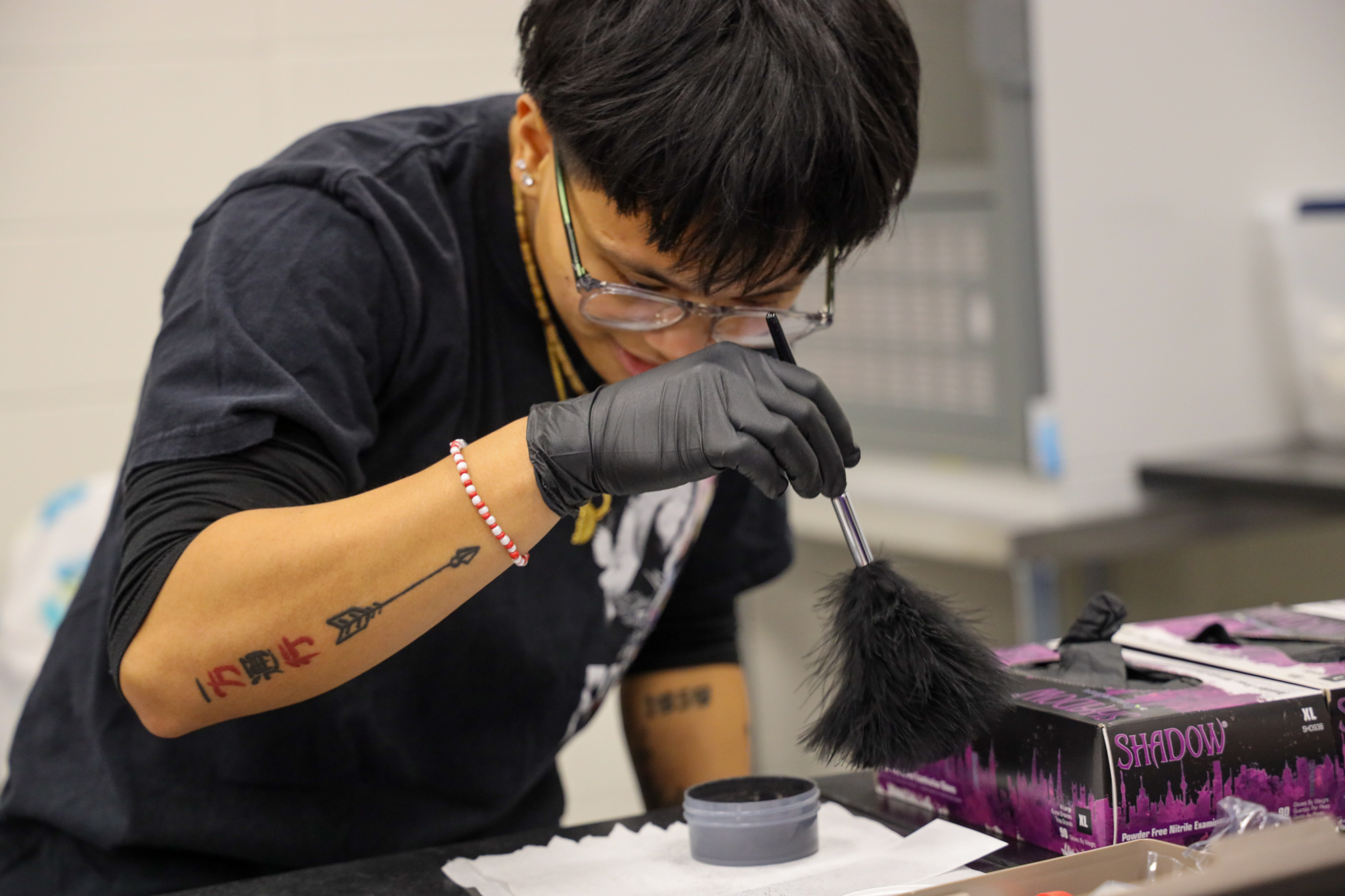 Student dusting for fingerprints