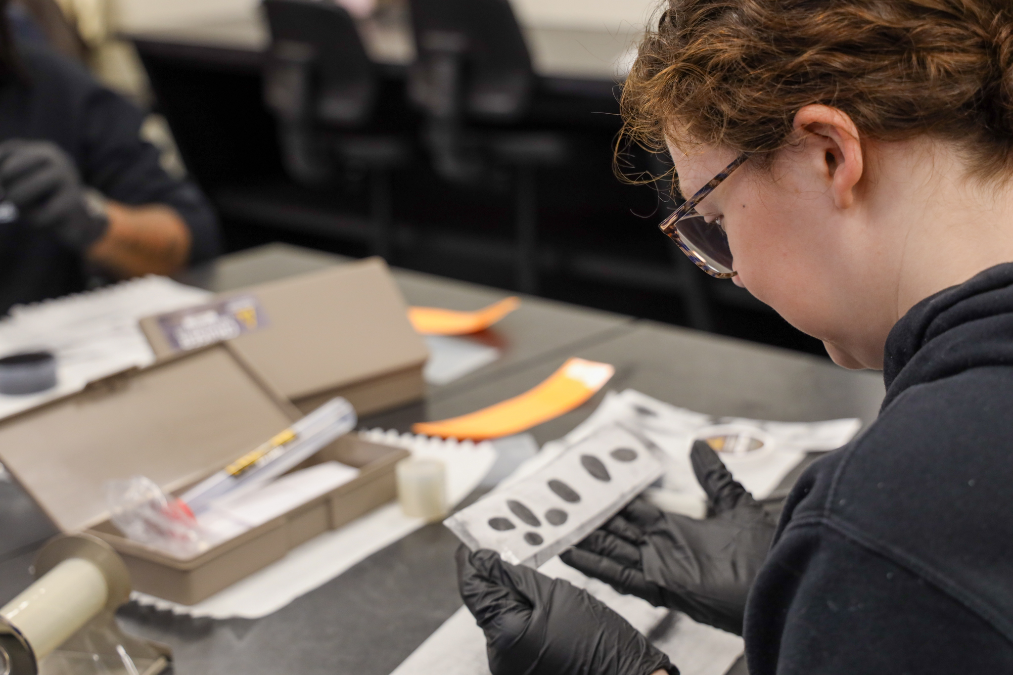 Student examining finger prints