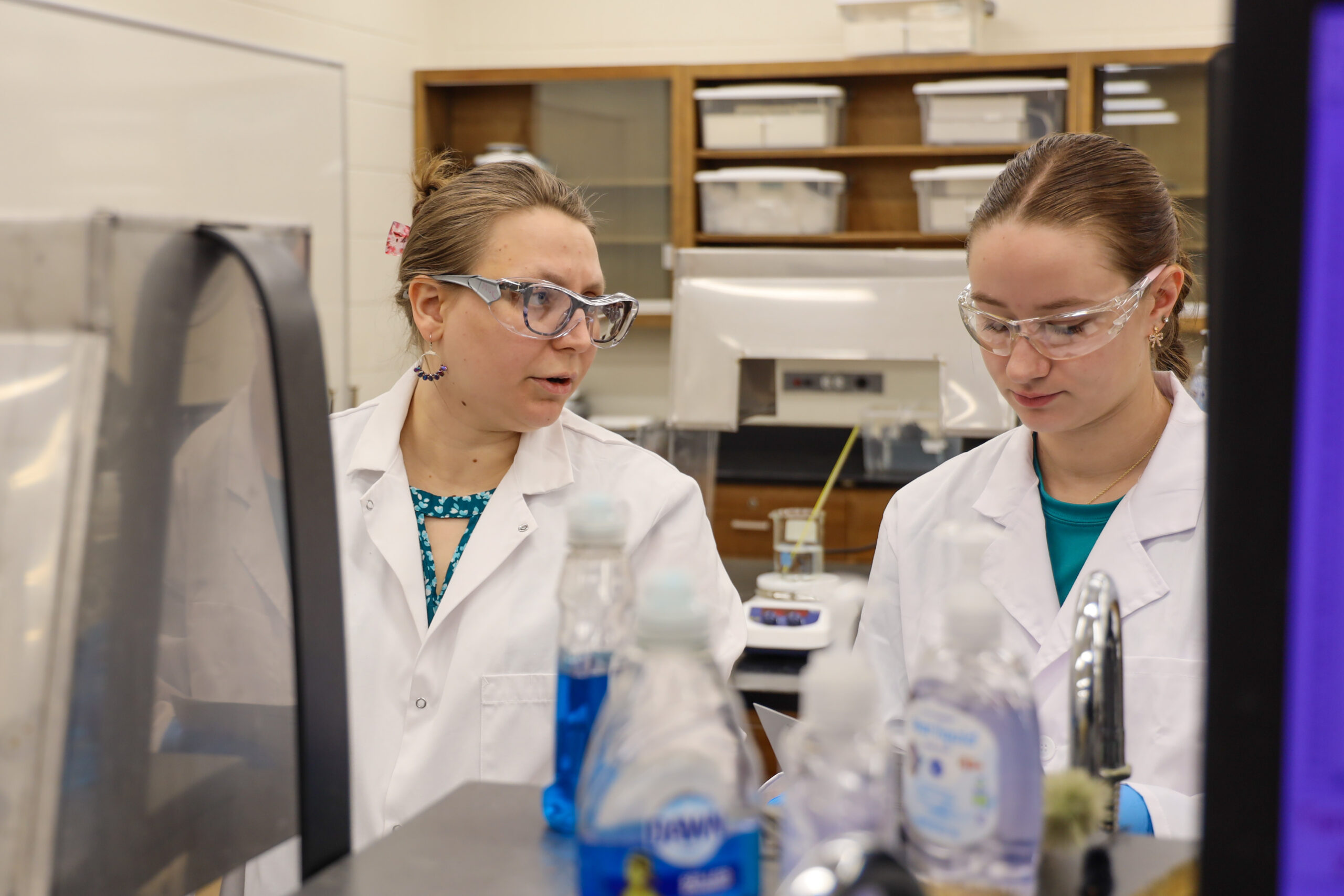 Instructor and student in chemistry lab