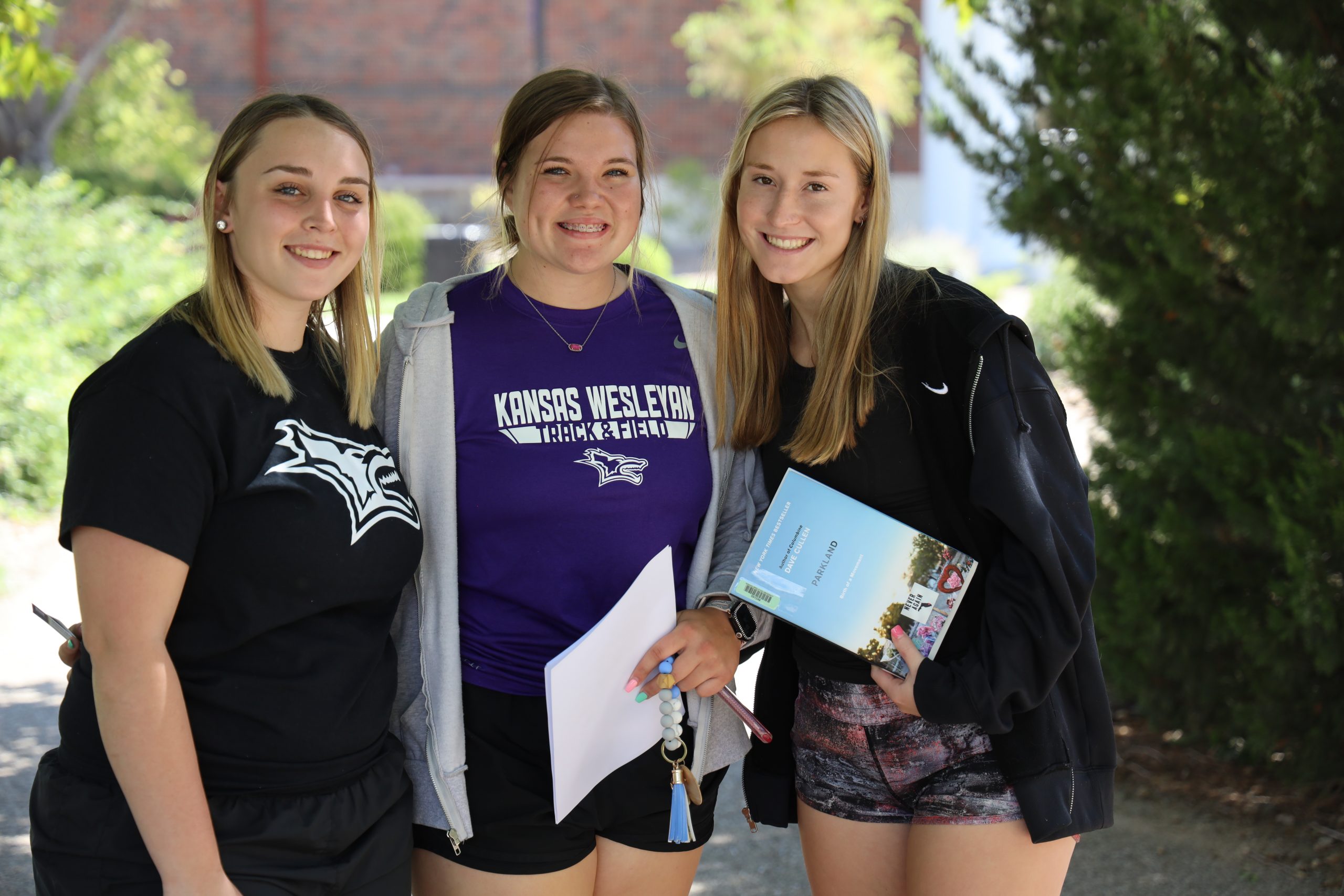 Three female students smiling for photo