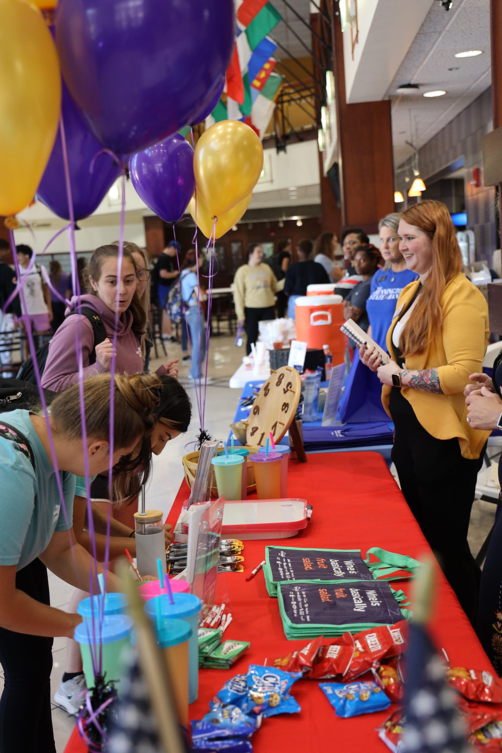 Tables and people interacting at fair