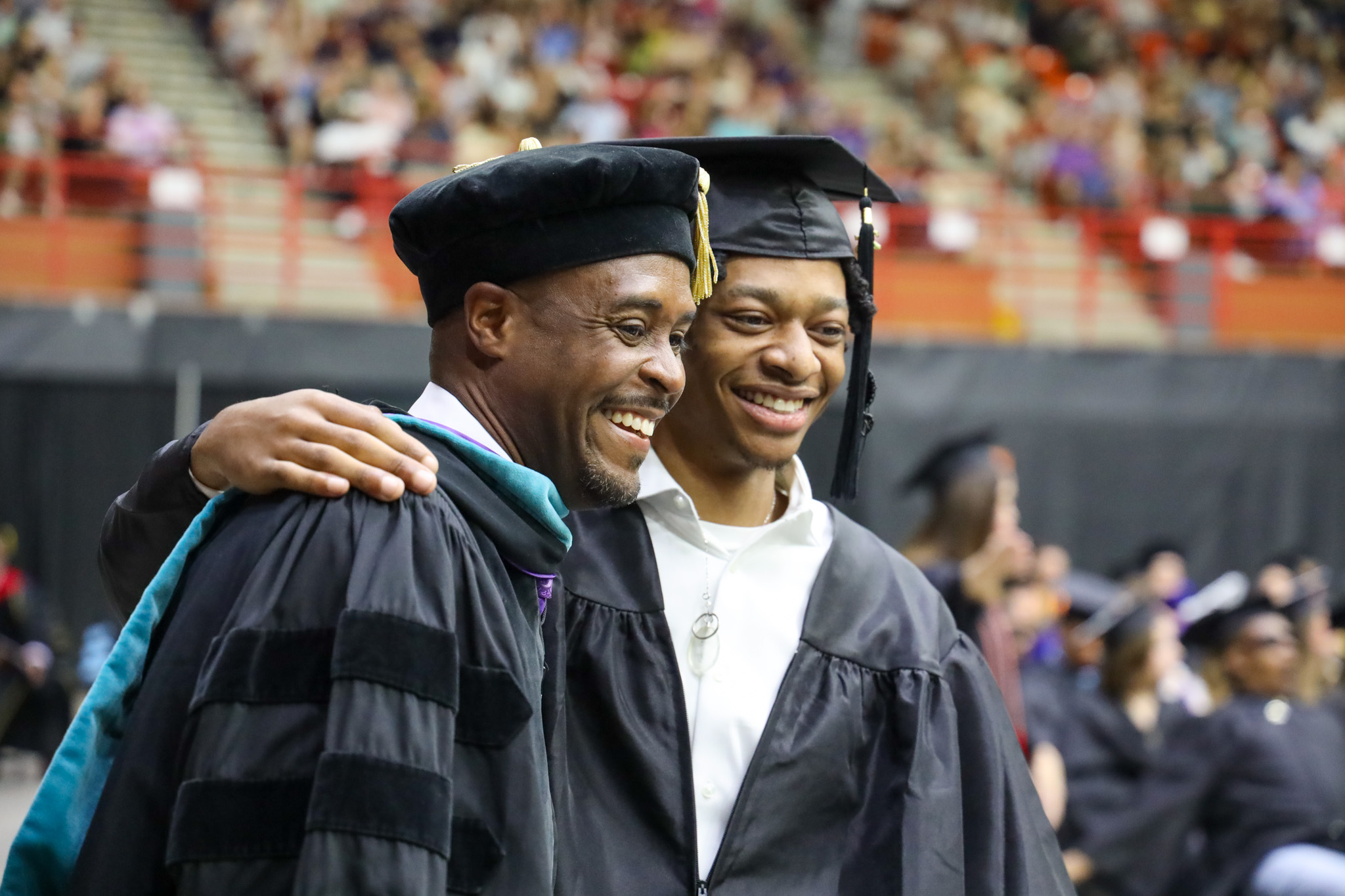 Man hugging graduation speaker