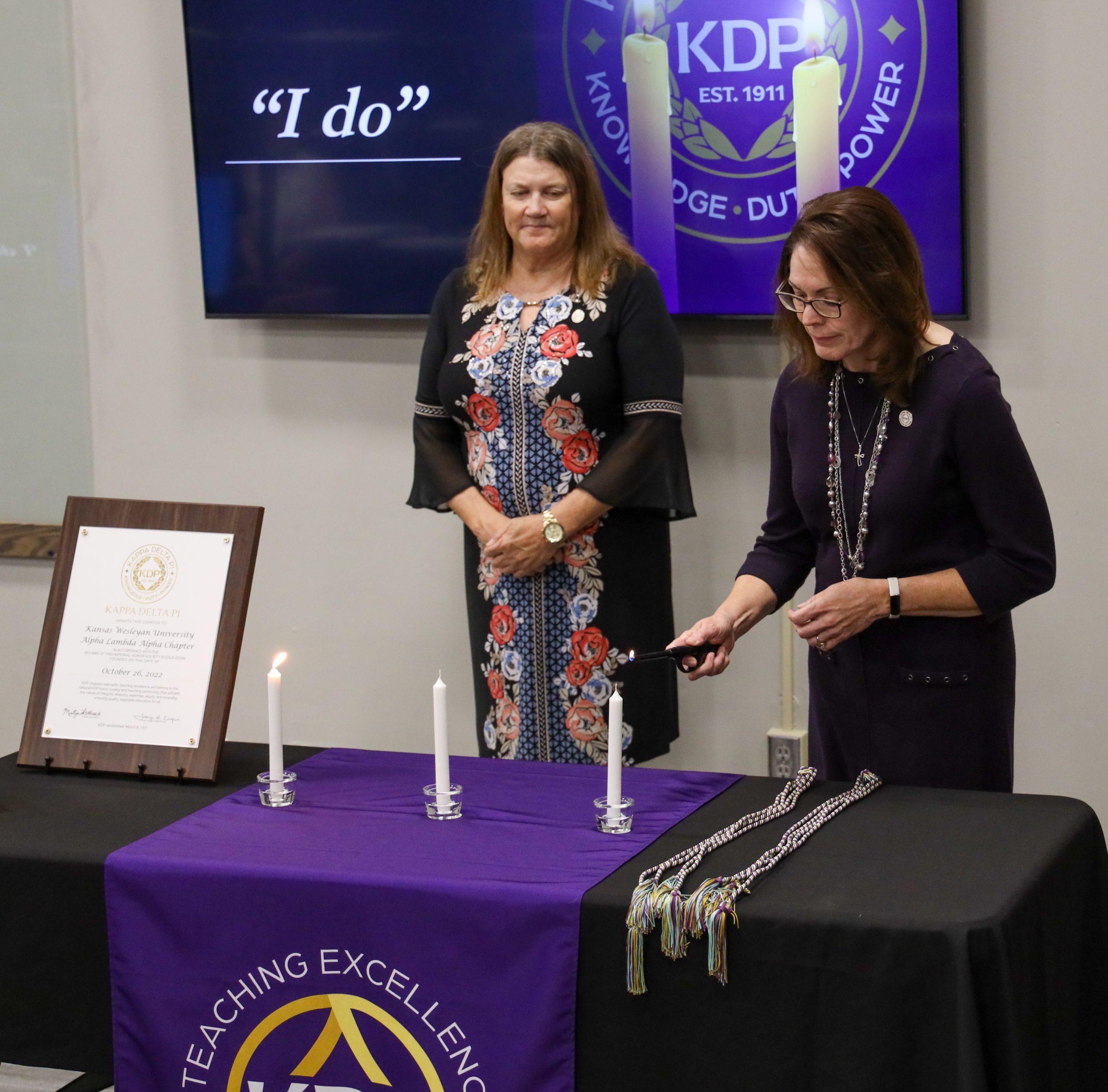 Woman lighting candle at education event