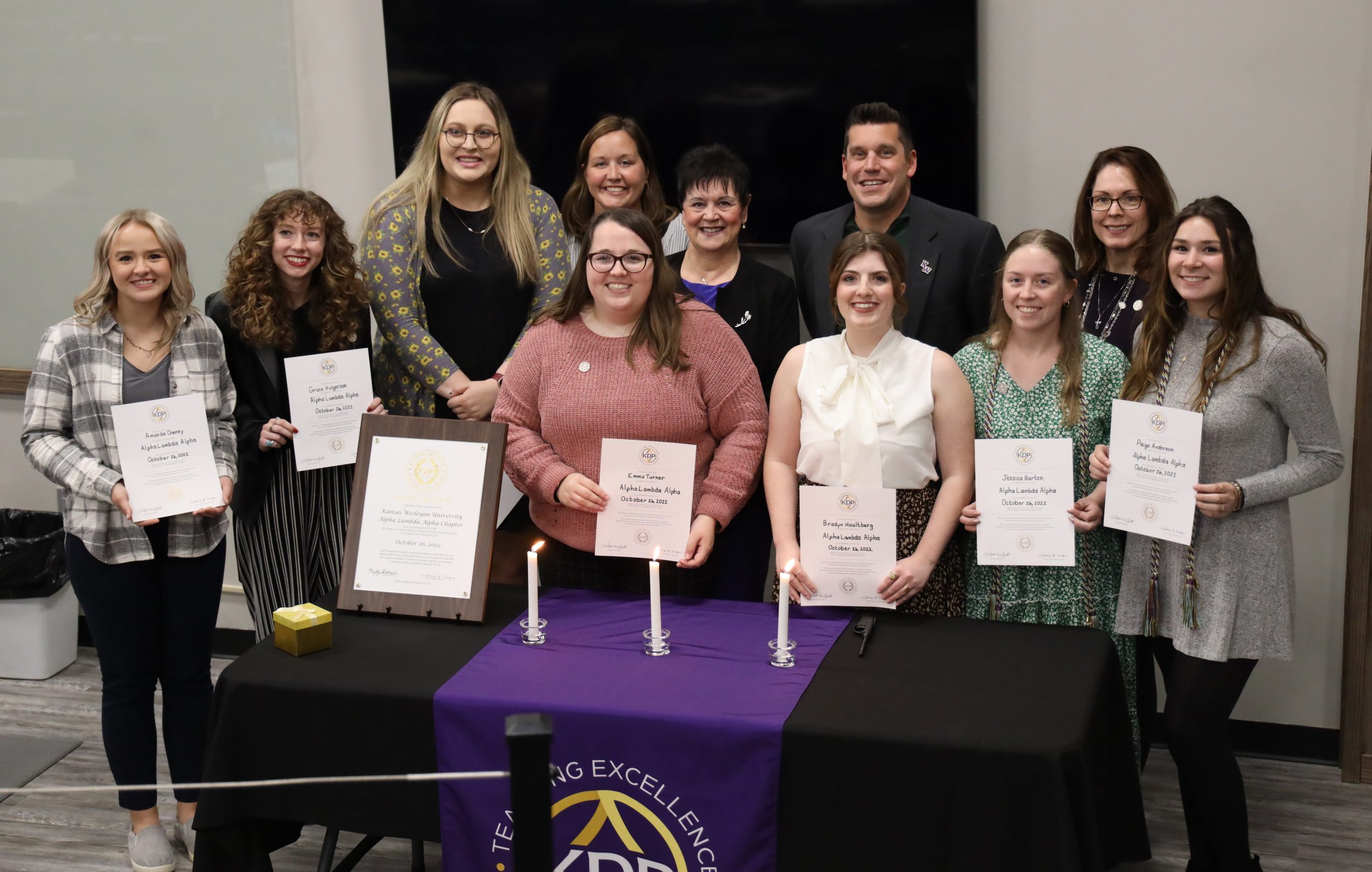 Students holding certificates at education event