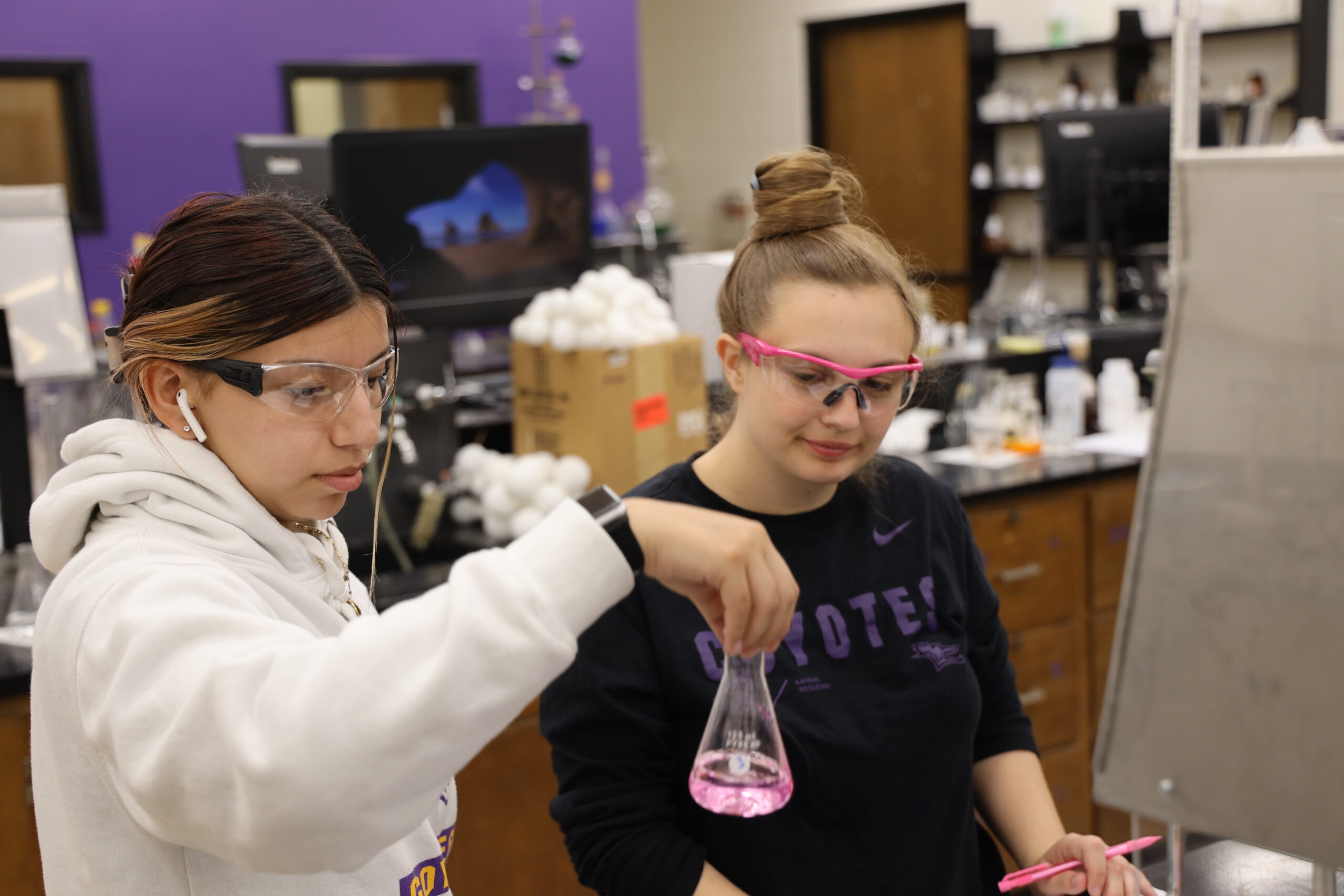 Students examine chemicals in beaker