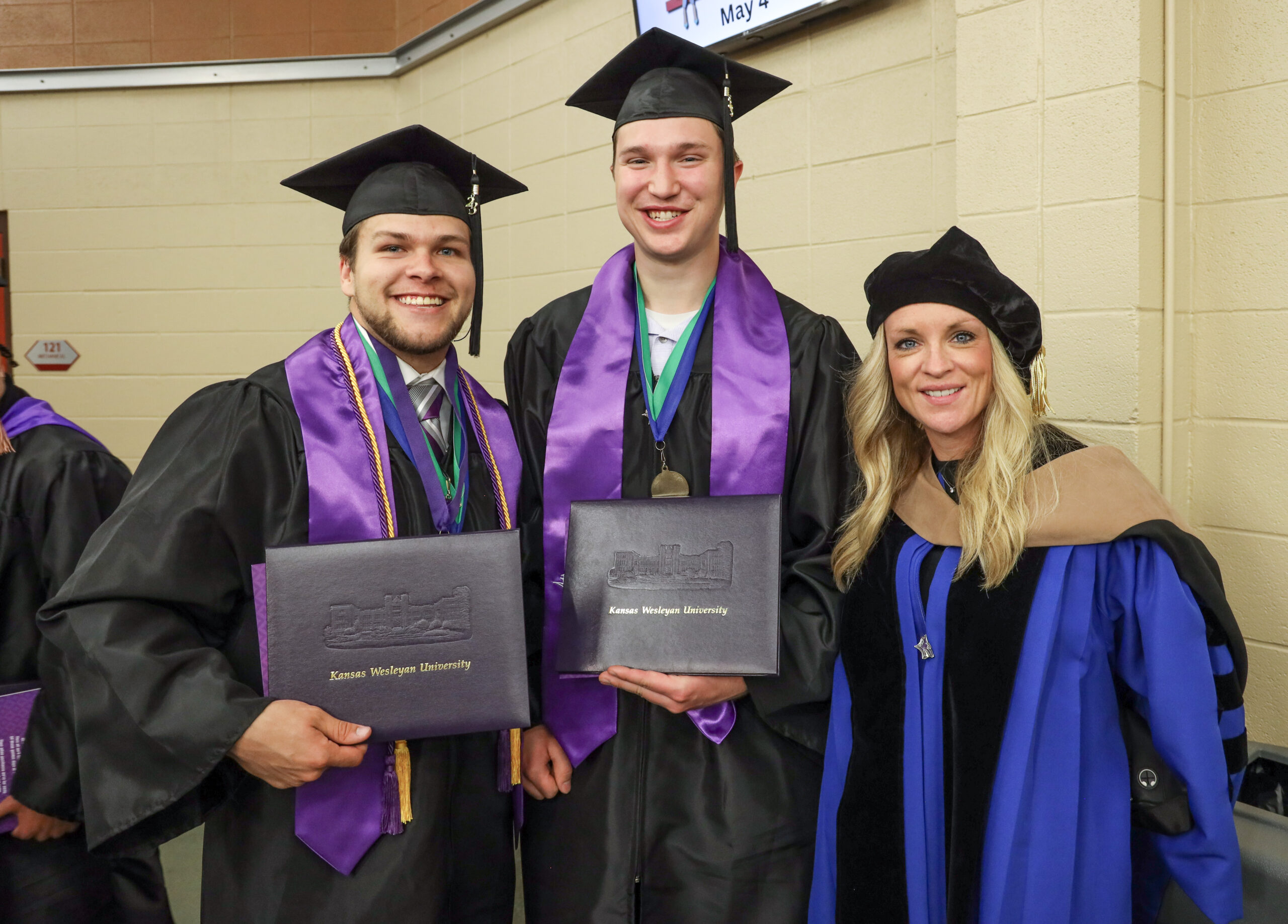 Students with professor at graduation