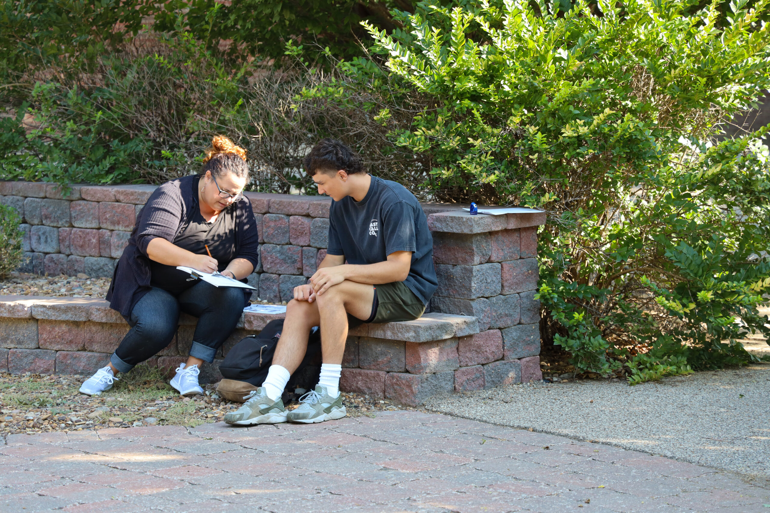 Teacher working with student outside