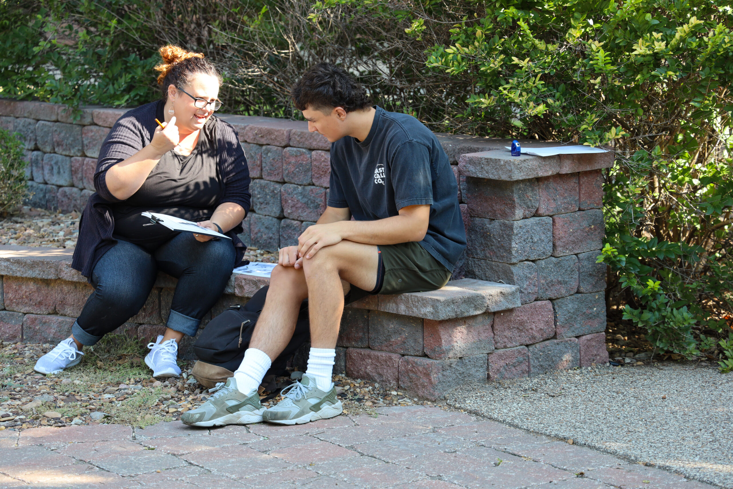 Teacher working with student outside