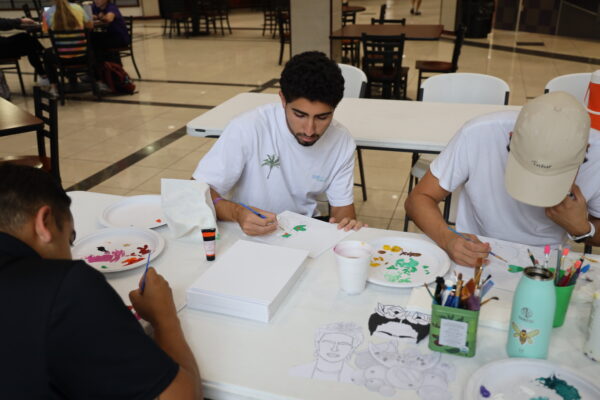 Student painting pictures of Frida Kahlo