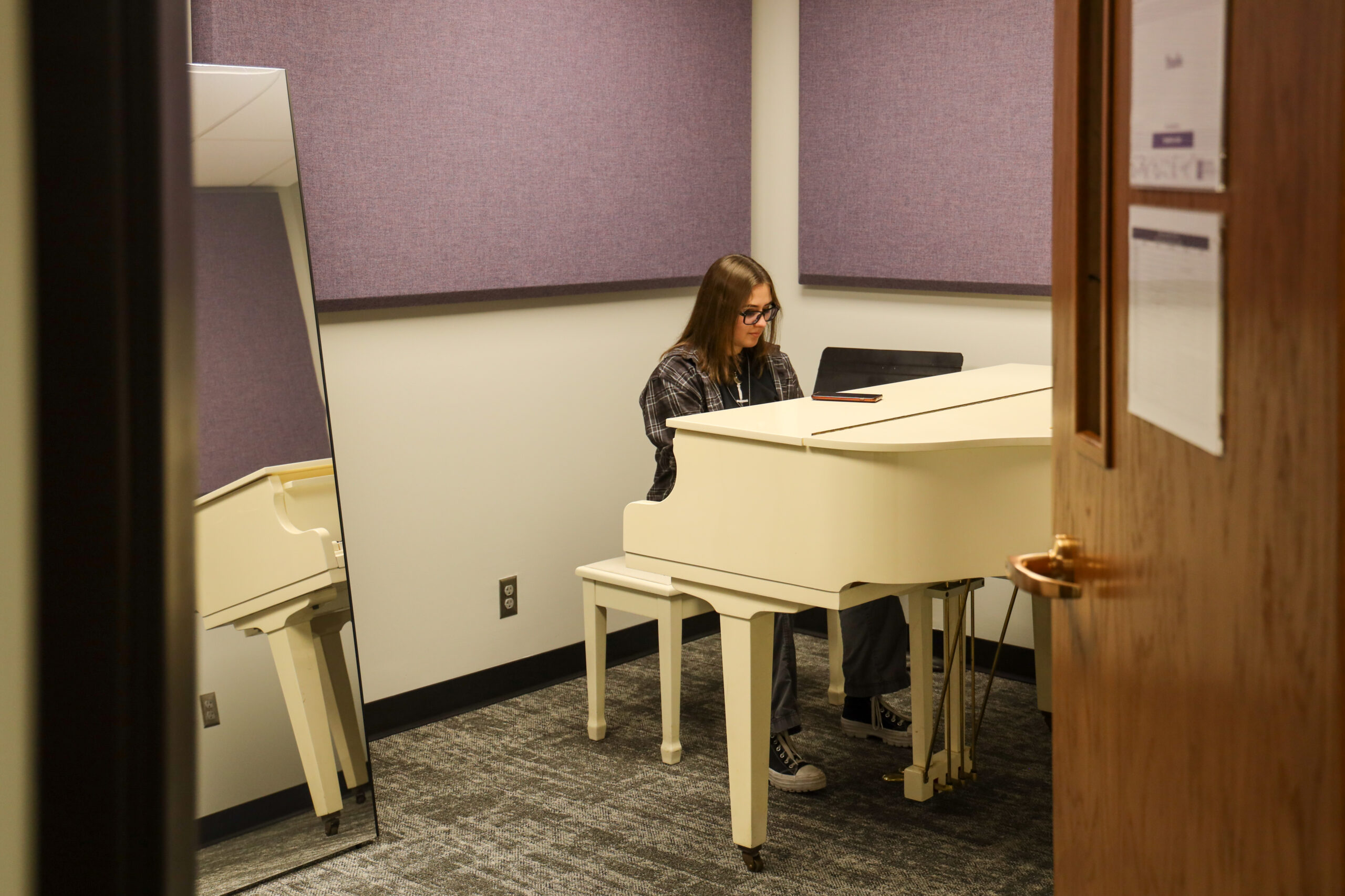 Student rehearsing on piano.