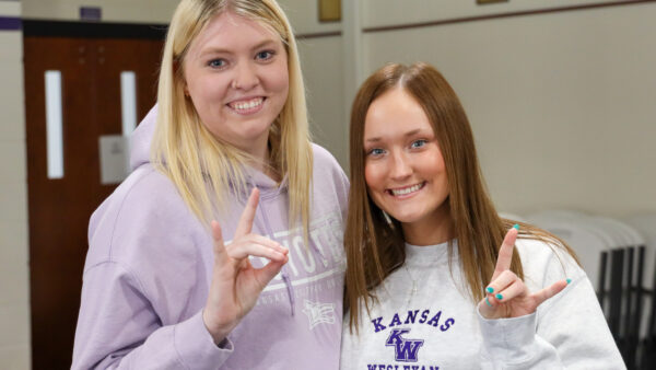 Female Students doing Yote Symbol