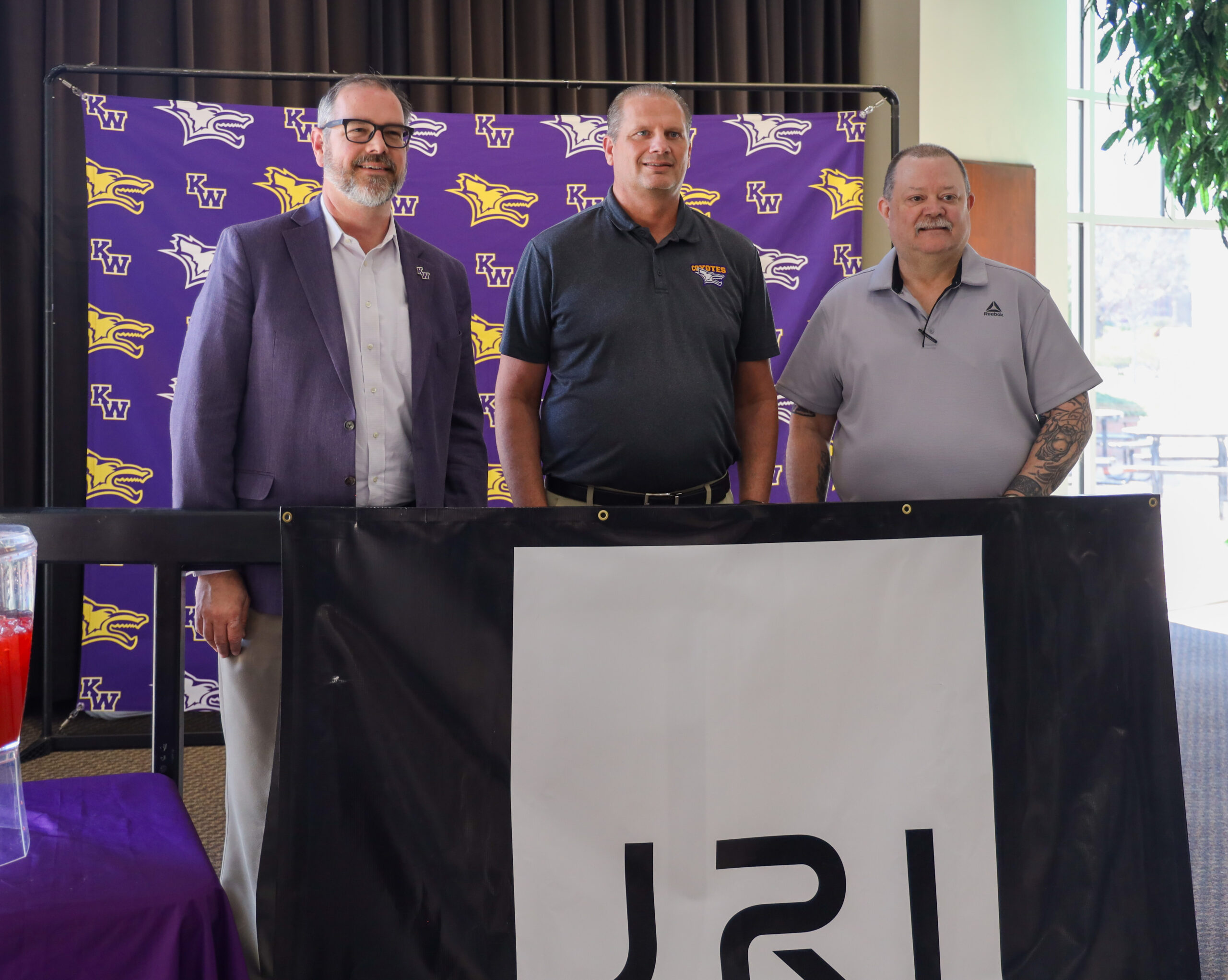 JRI announcement 2024, three men posing behind sign