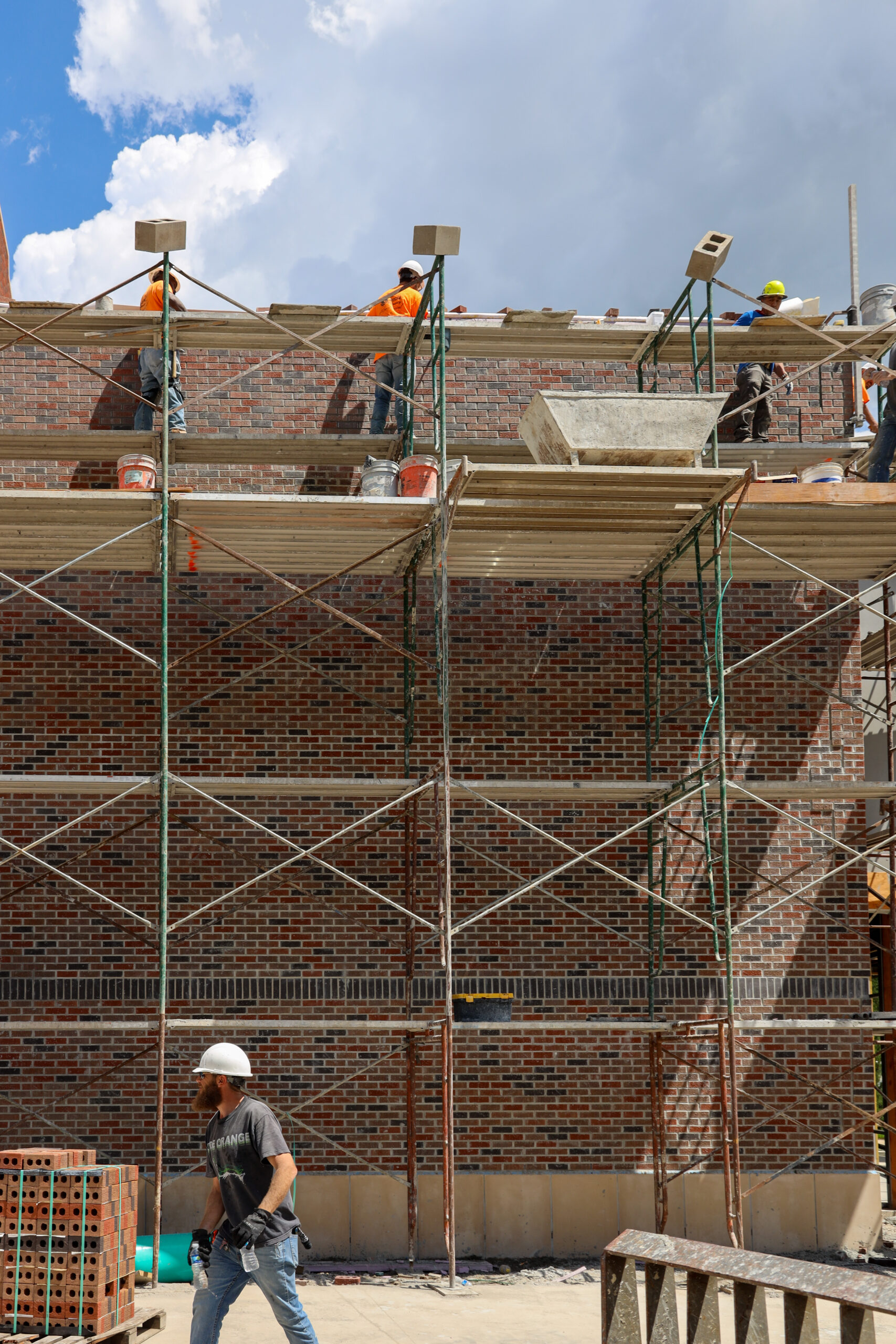 Workers constructing new Pioneer Hall entrance on scaffolding