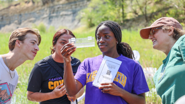 Biology students collecting samples at the river