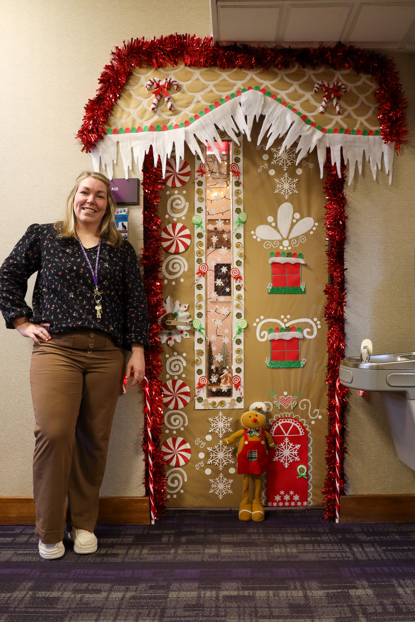 Woman standing by door decorations