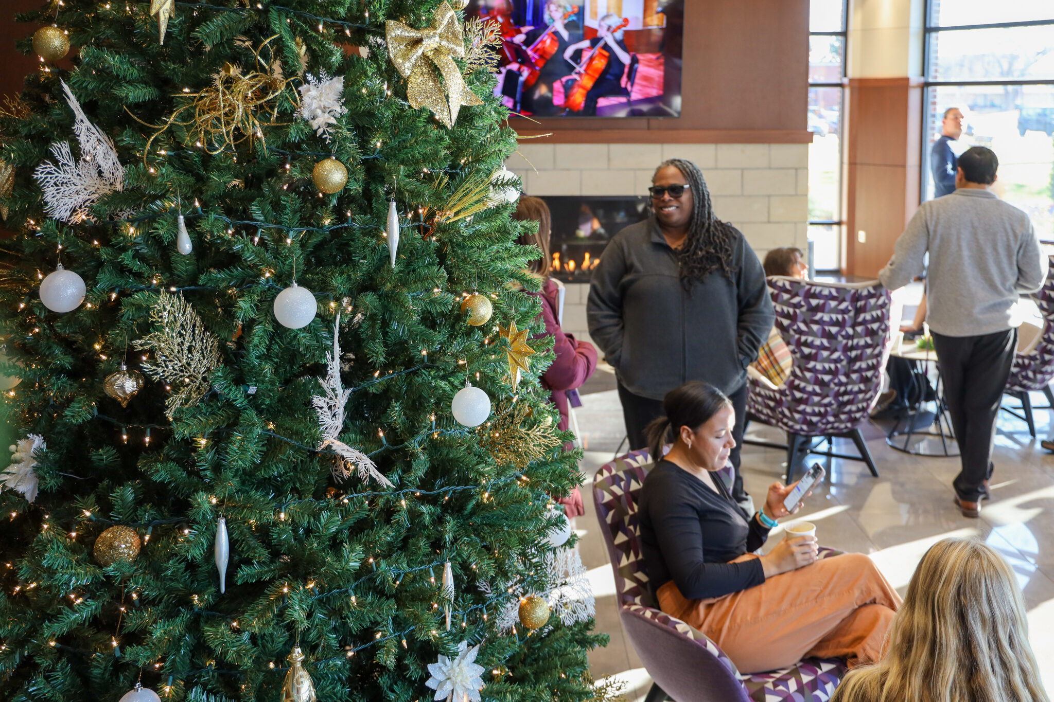 Individuals by Christmas tree