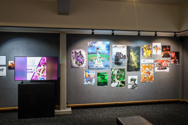 Graphic design pieces being displayed within the gallery.