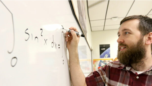 KWU student writing on white board
