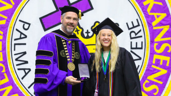 KWU student with president at graduation