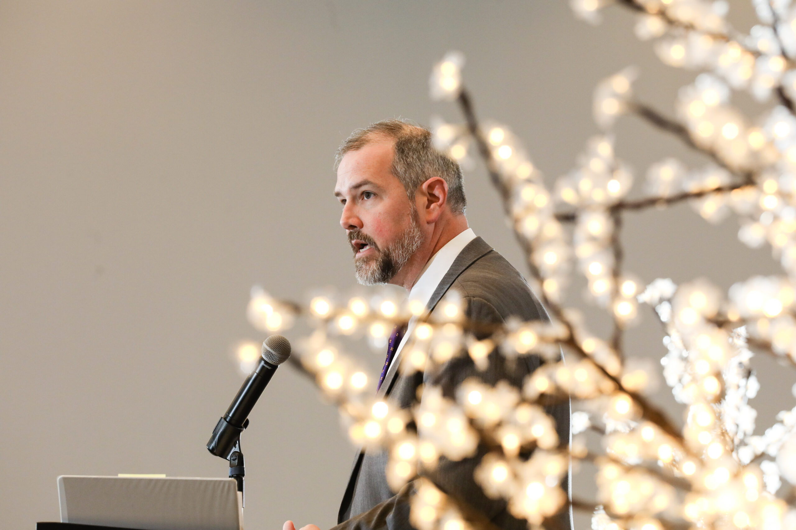 A man speaks at a podium