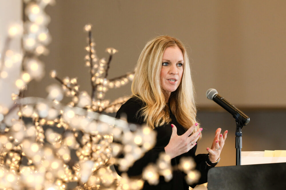 A woman speaks at a podium