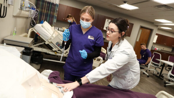 Instructor guiding student through simulation
