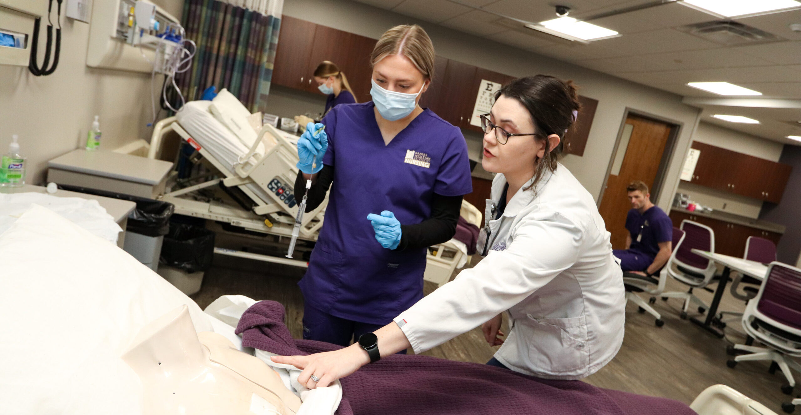 Instructor guiding student through simulation