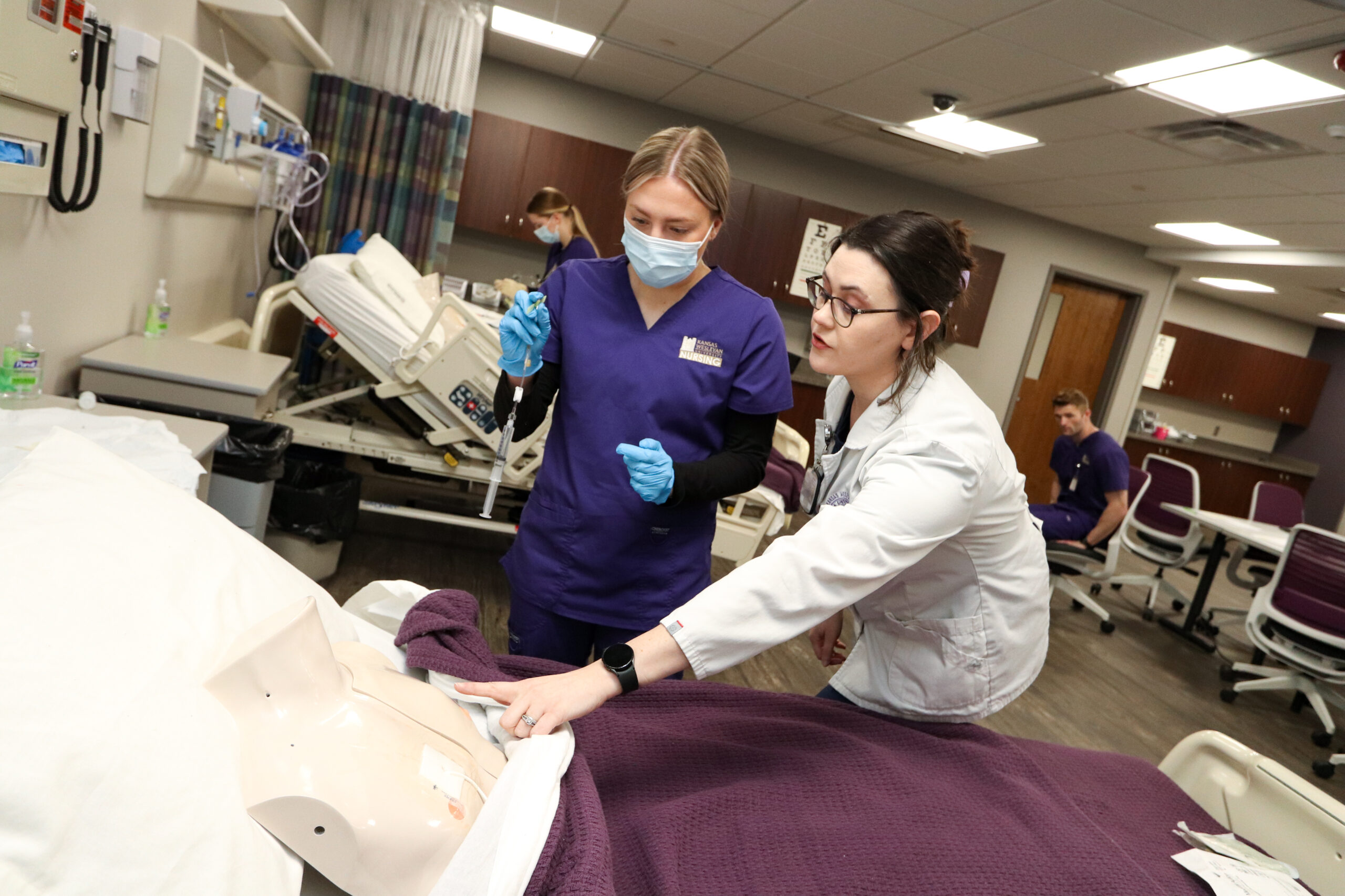 Instructor guiding student through simulation