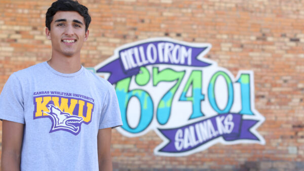 Guy in front of Salina sign