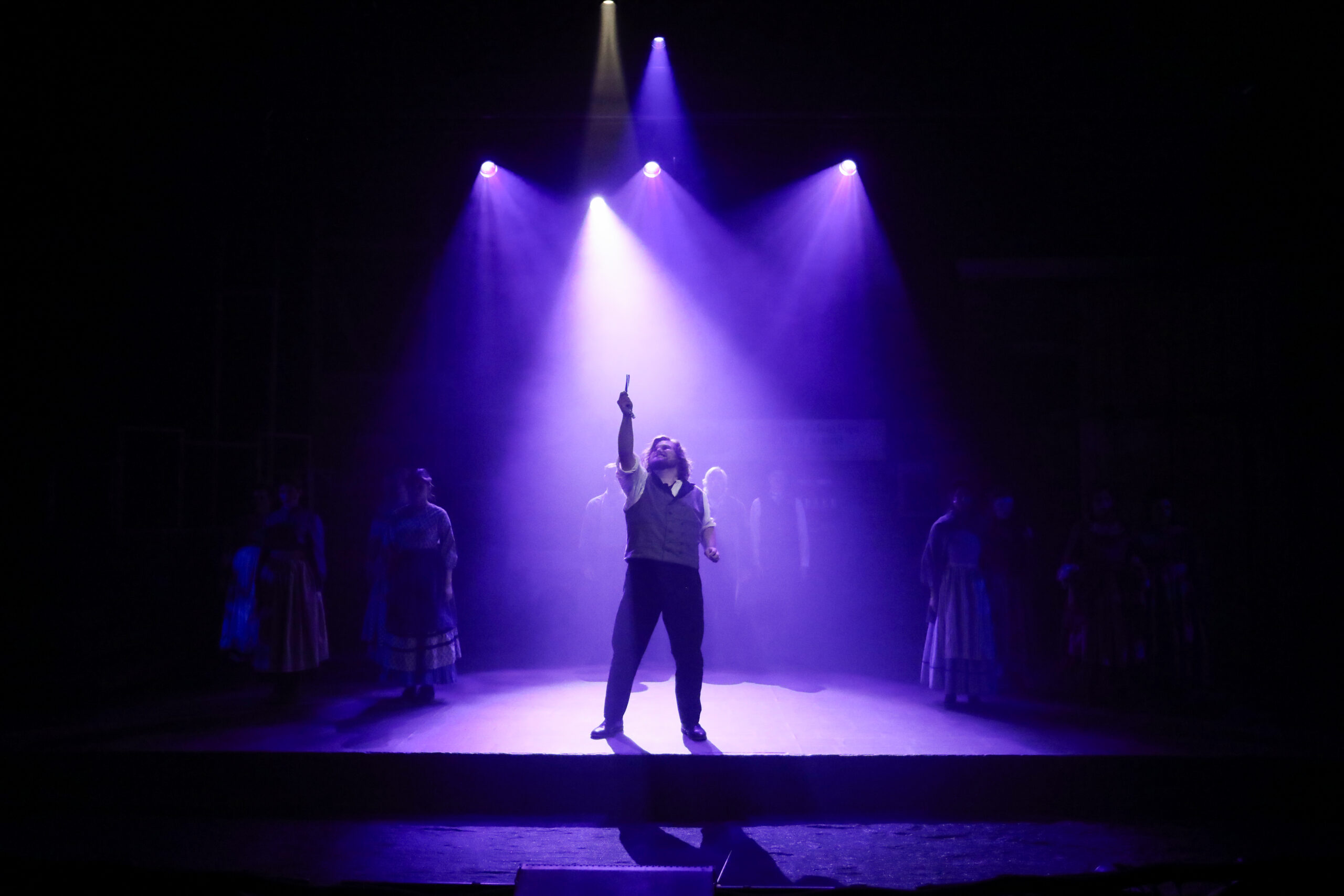 Theatre student under the lights during performance