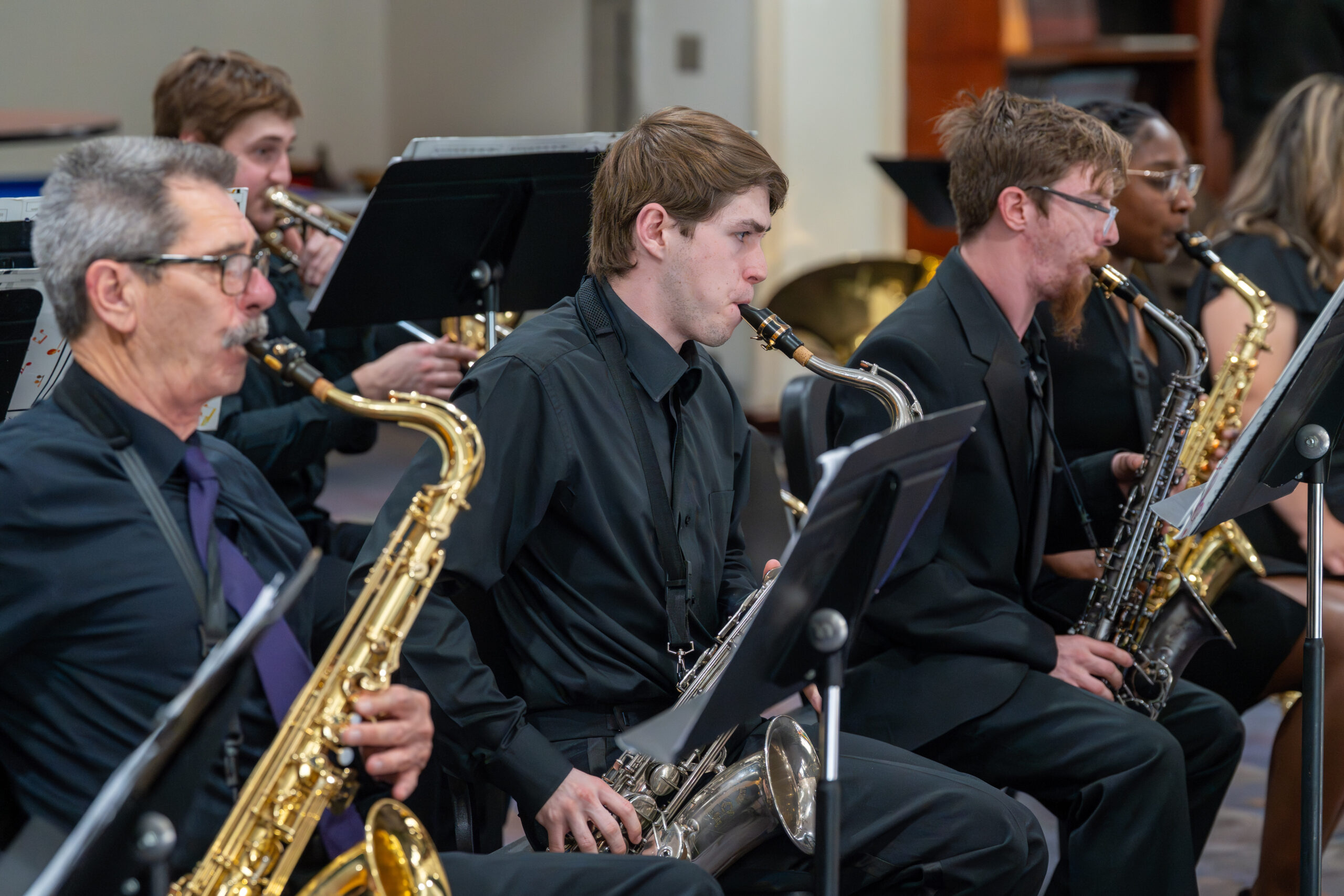 Three men playing saxophone