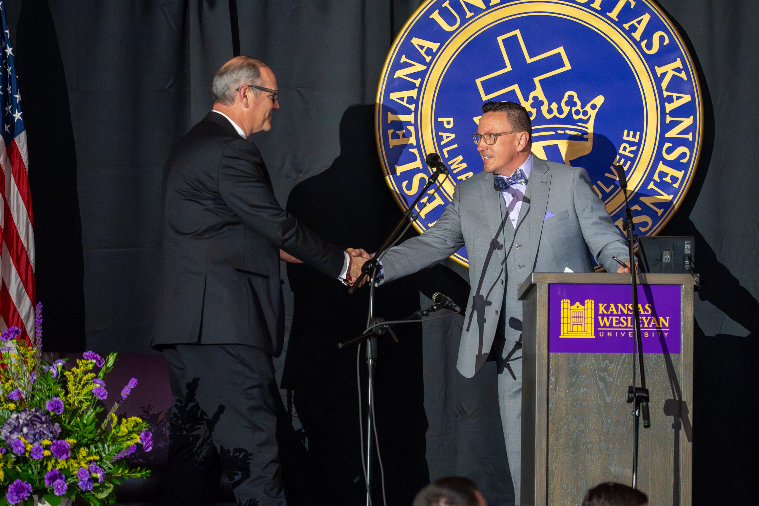 KWU president and EVP shaking hands