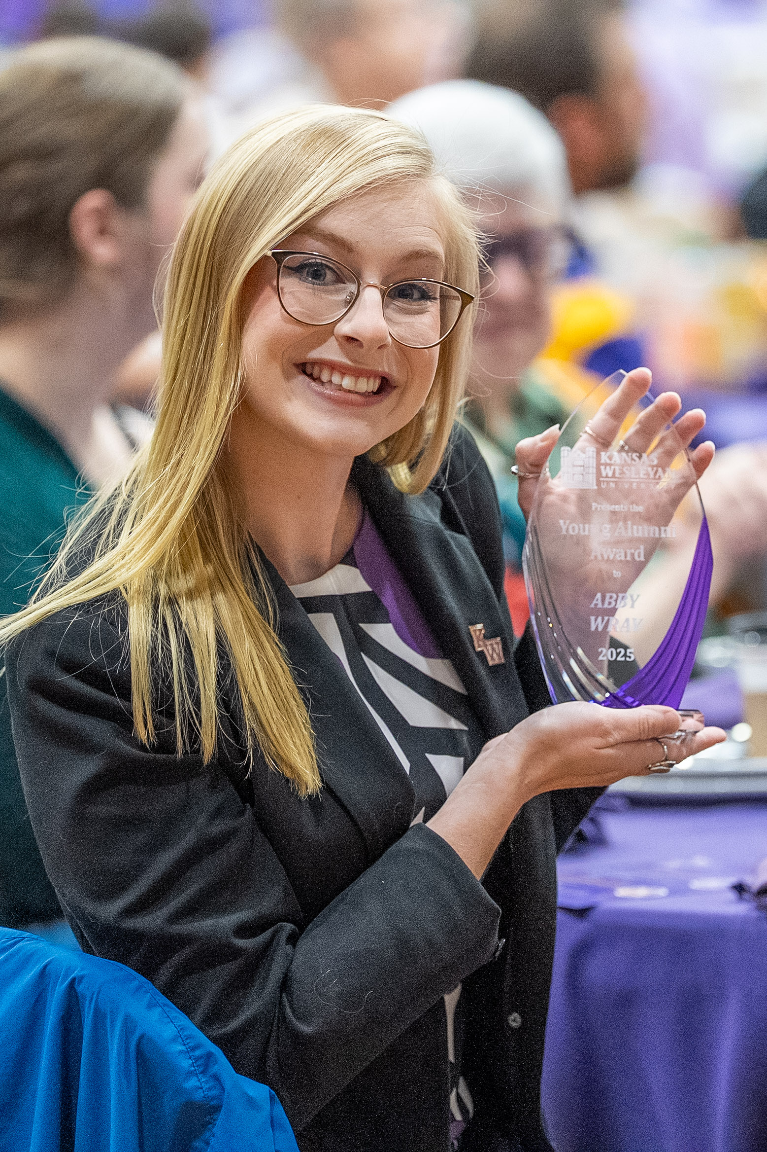 Woman holding up award