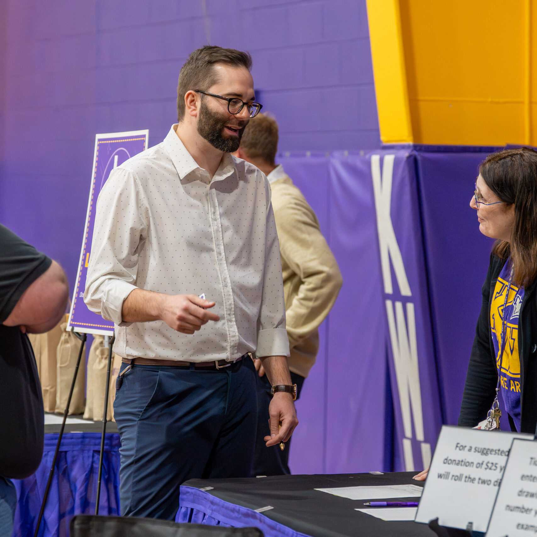 Man talking to people at table