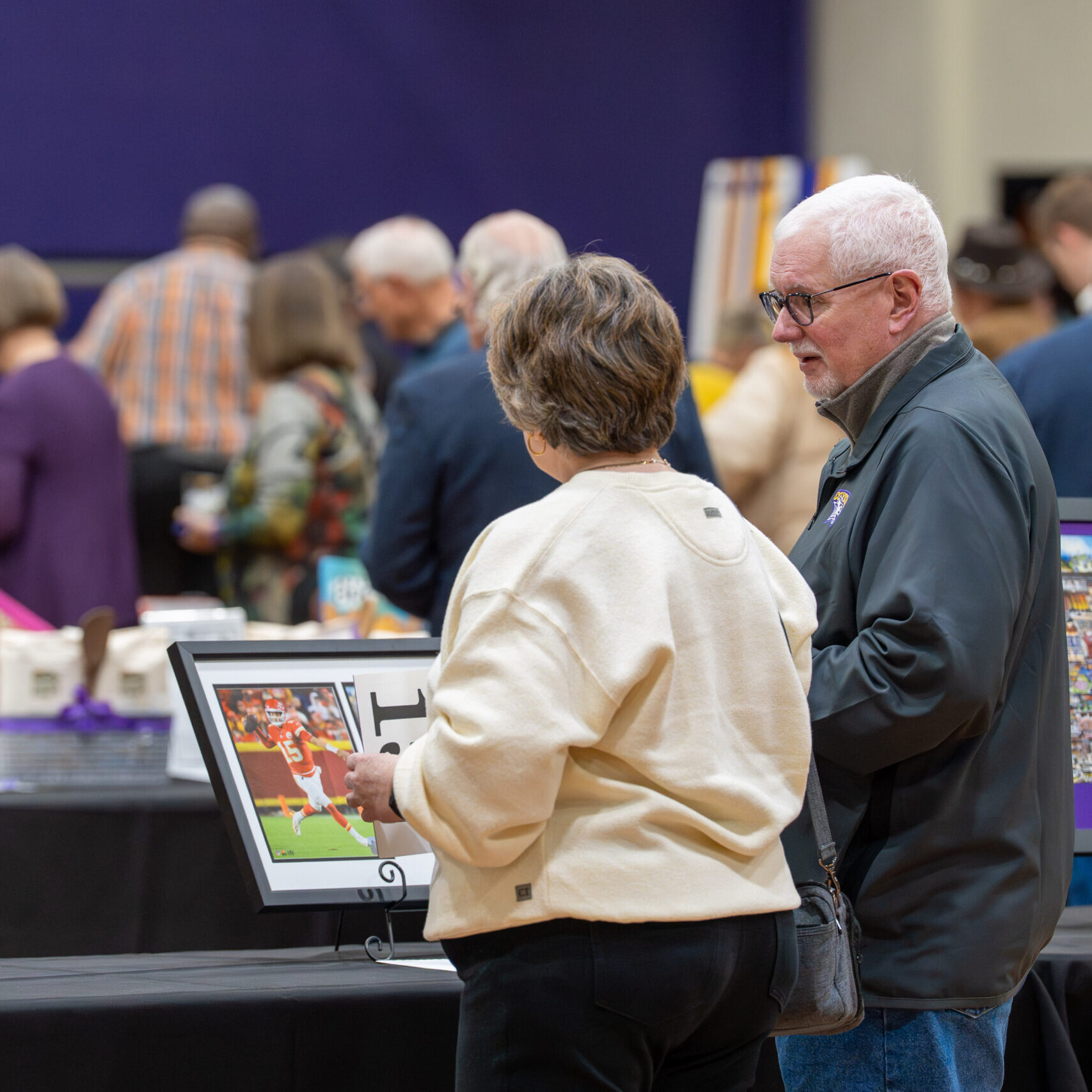 Man and woman looking at items on table