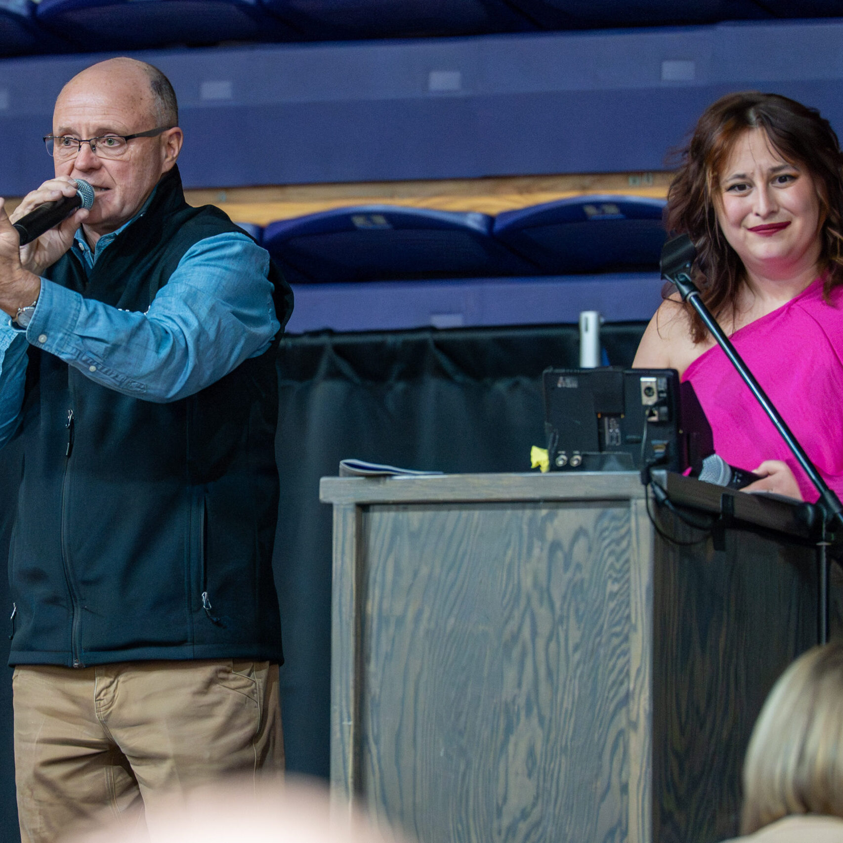 Auctioneer and woman on stage