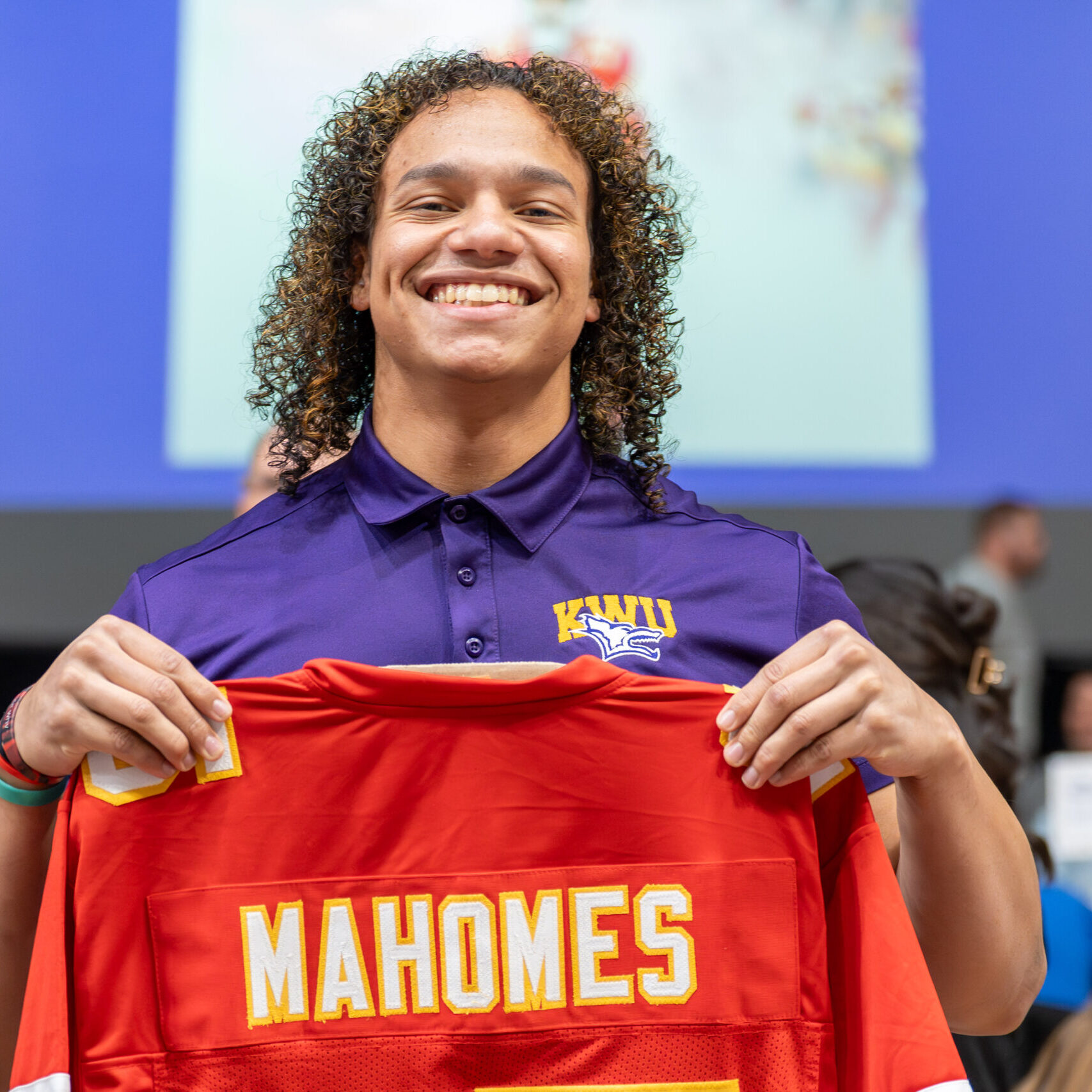 Man holding up jersey