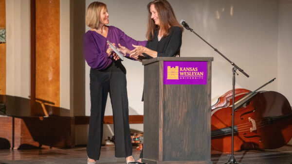 Woman accepting award from other woman