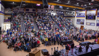 Wide-angle shot of capacity crowd in arena