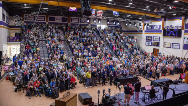 Wide-angle shot of capacity crowd in arena
