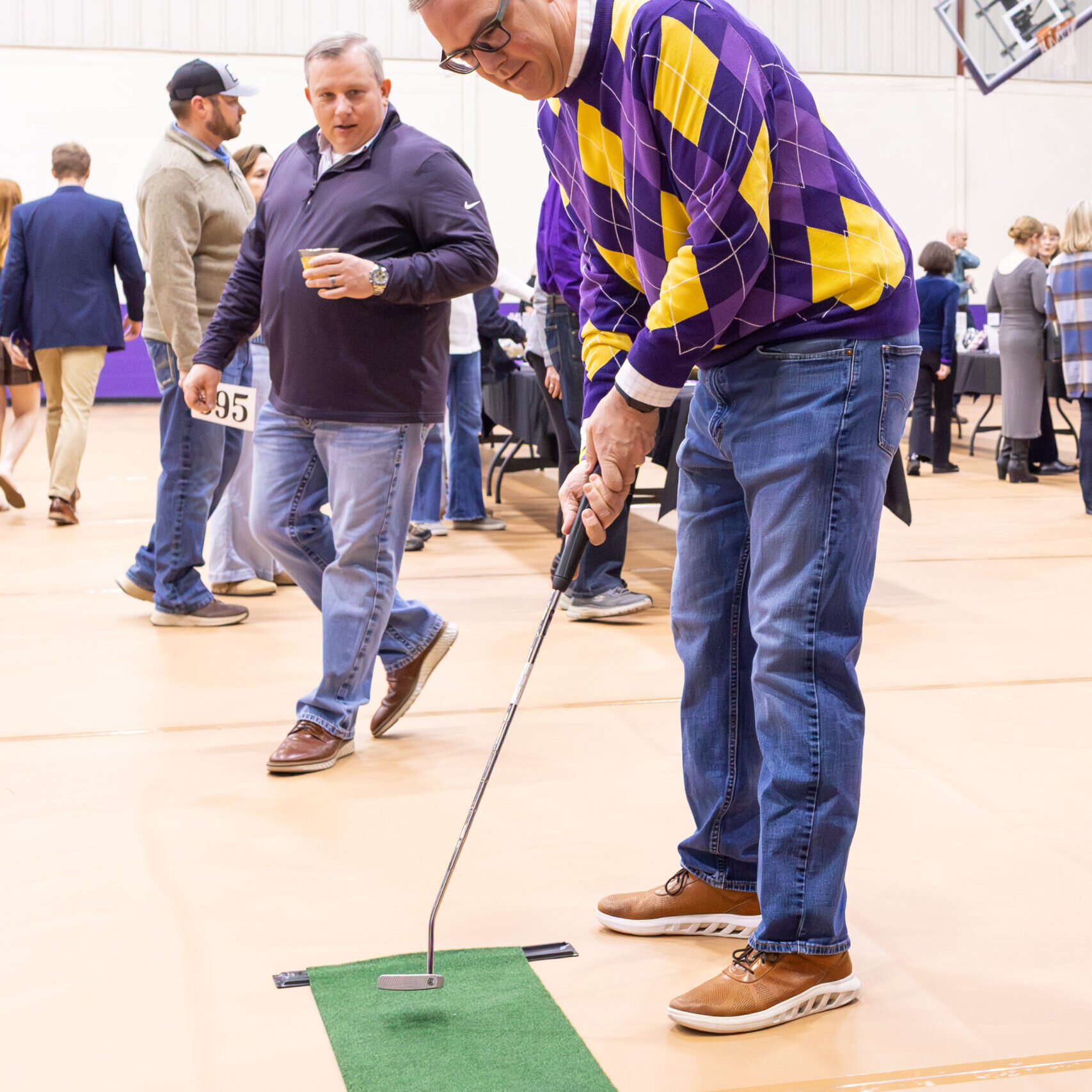 Man attempting mini-golf putt