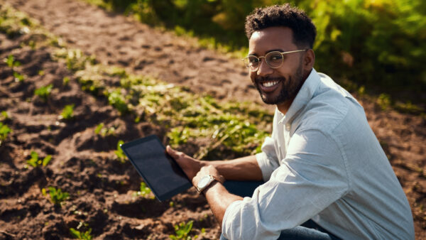 Man leaning down into soil