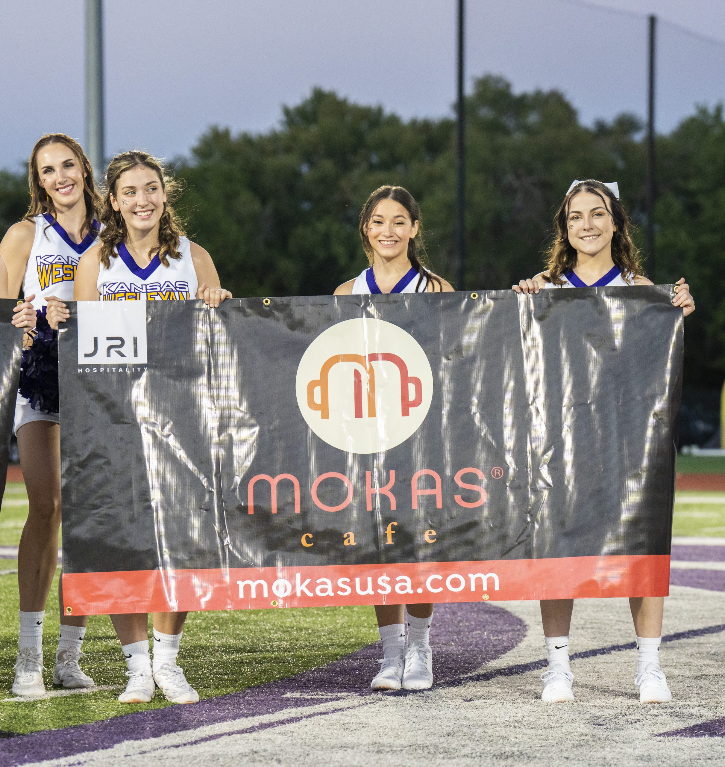 Cheerleaders holding banner