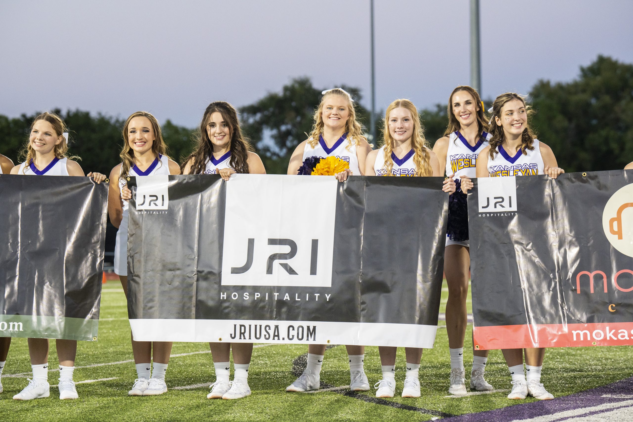 Cheerleaders holding banner