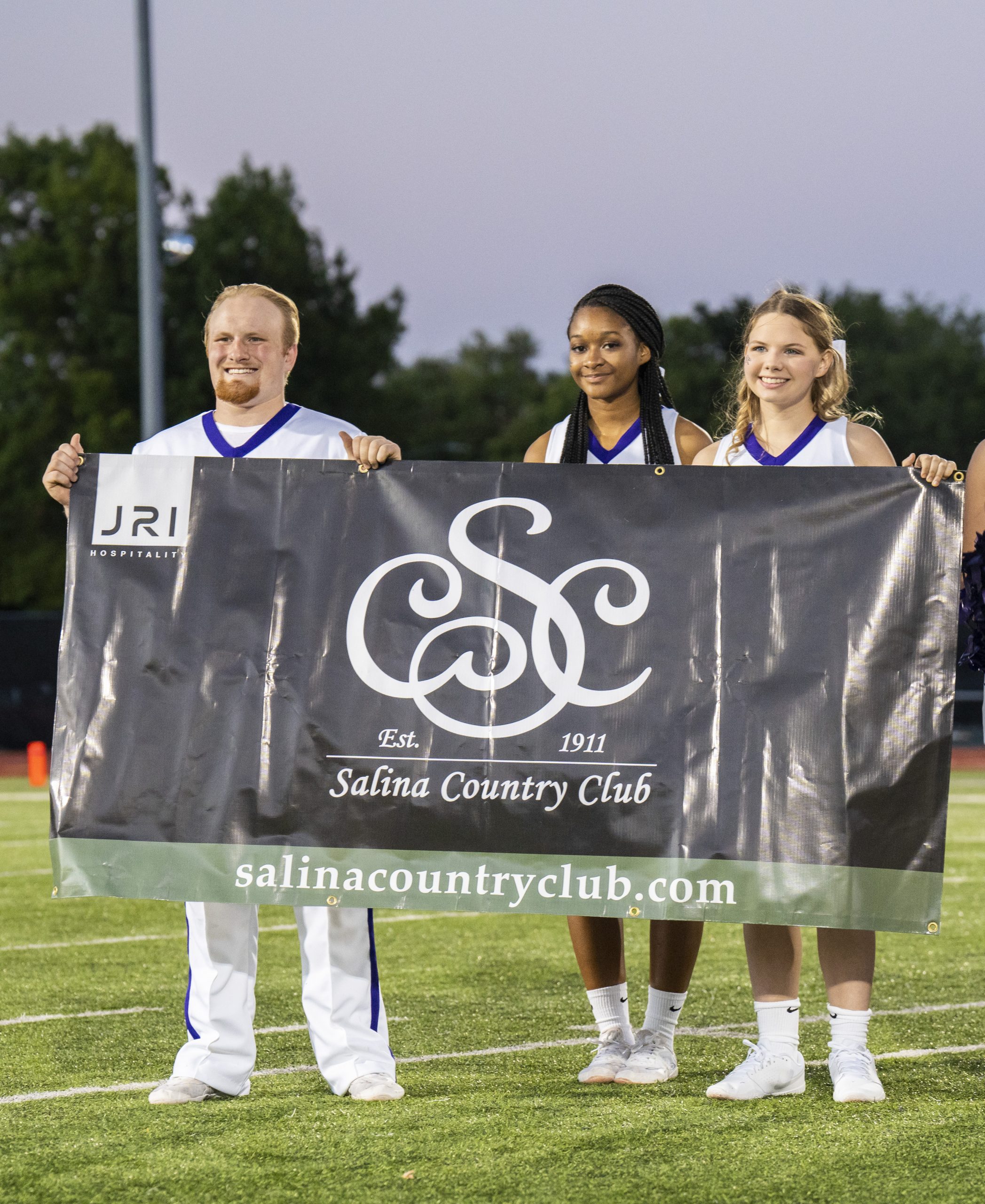 Cheerleaders holding banner