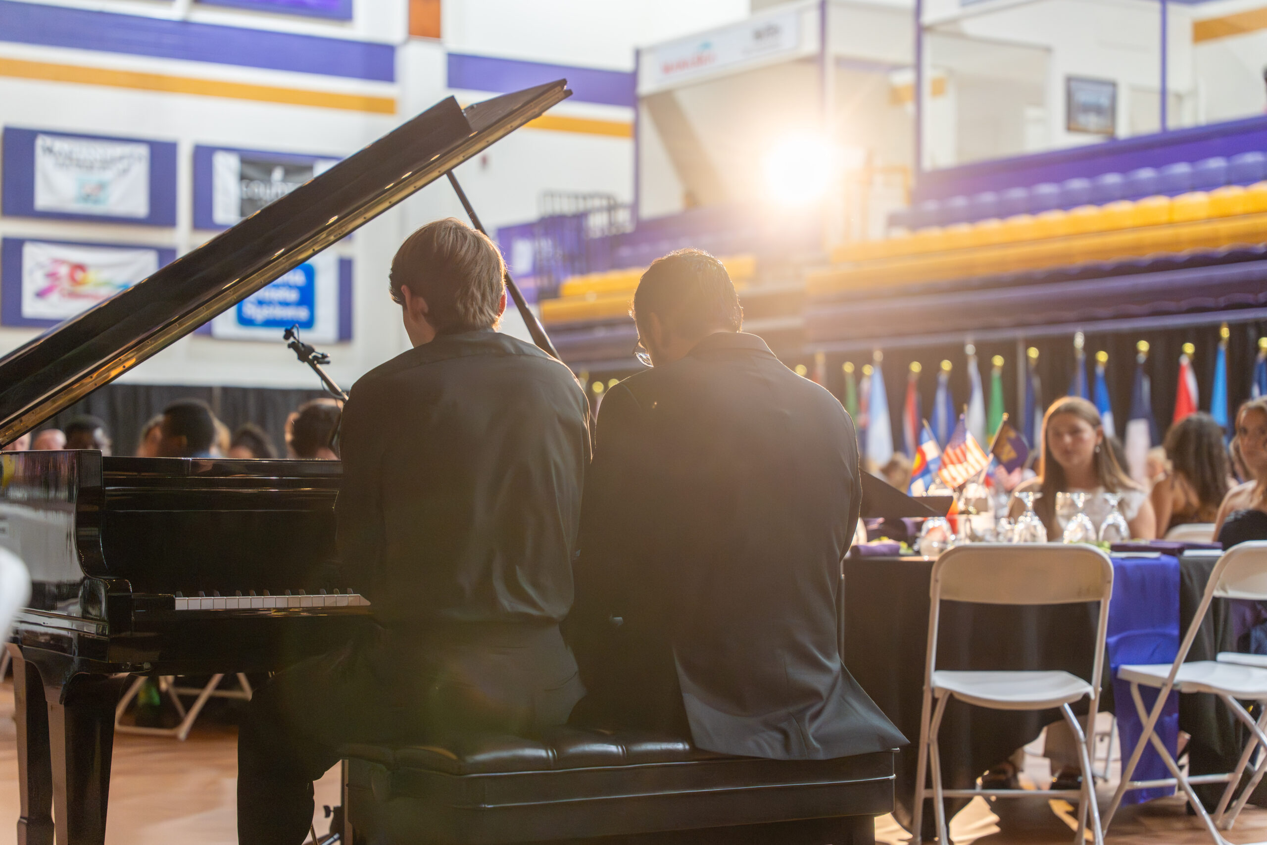 Two people playing piano