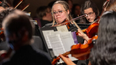 Woman playing stringed instrument