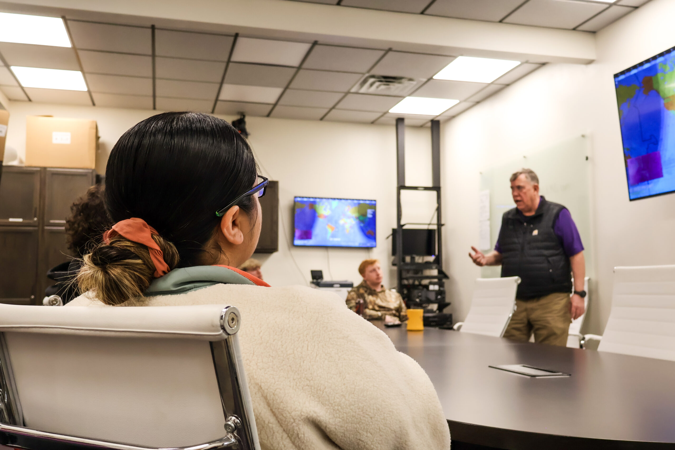 Student listening to instructor